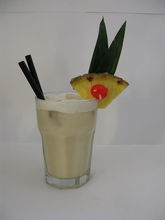 Piña Colada cocktail with pineapple and cherry garnish